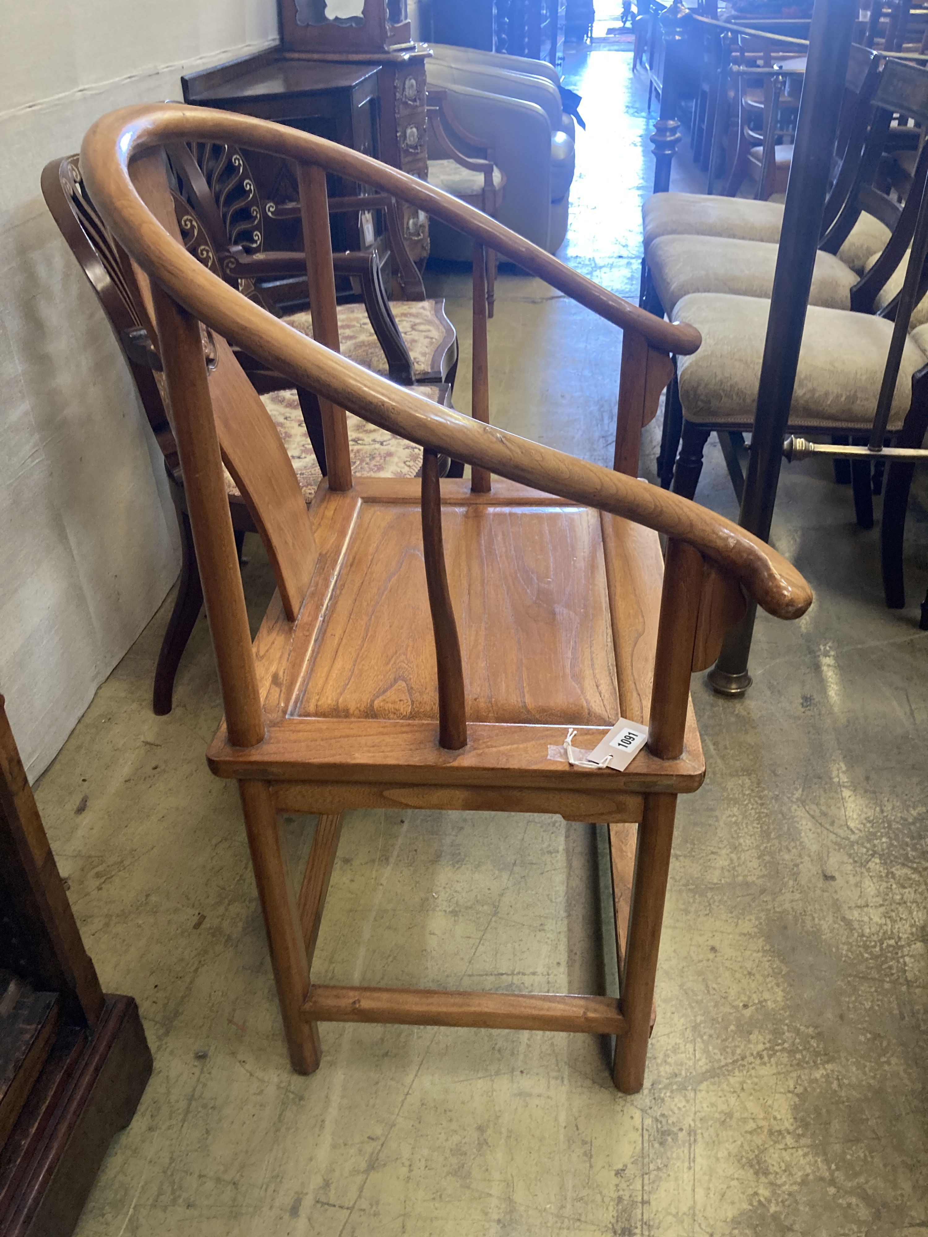 A Chinese elm armchair, with round back and pierced carved splat, width 67cm, depth 50cm, height 100cm